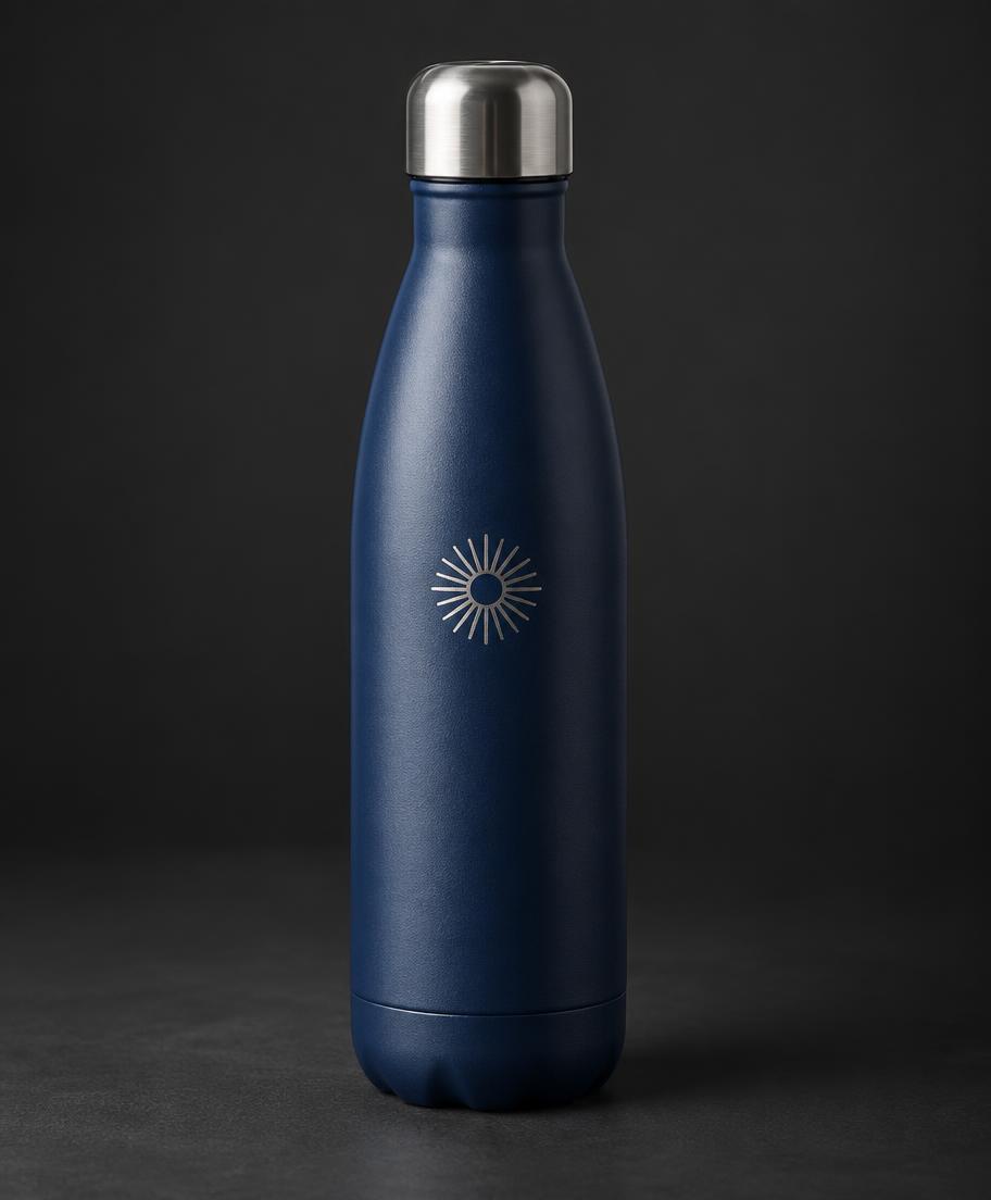 Illustrative navy bottle with a small silver engraved sunburst